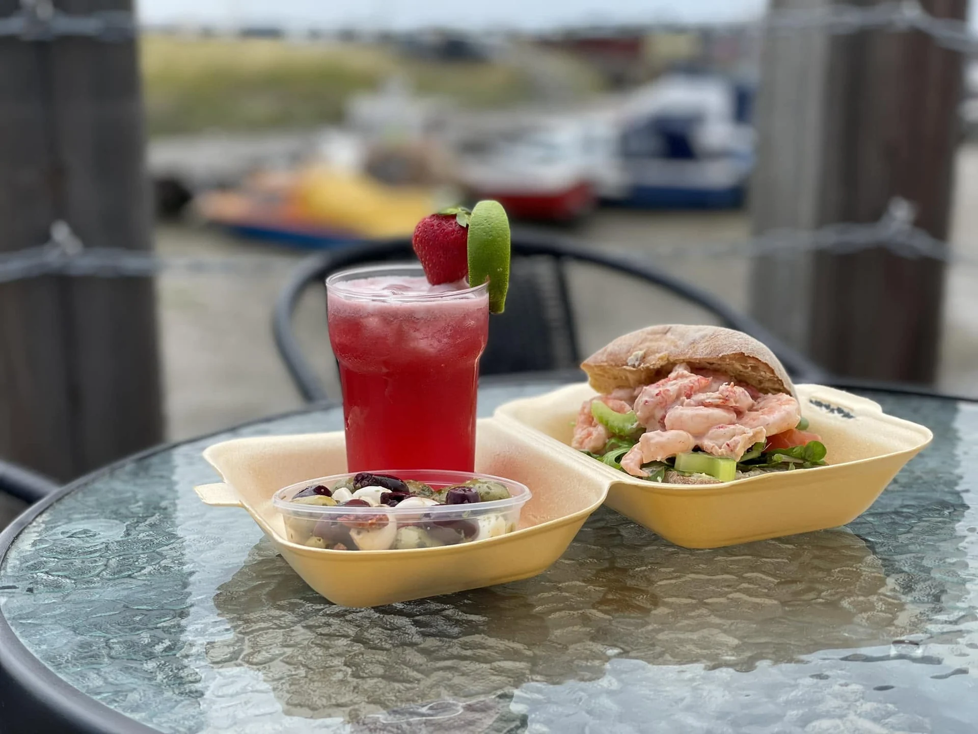Seafood roll, frozen drink and olives beside Queenborough harbour