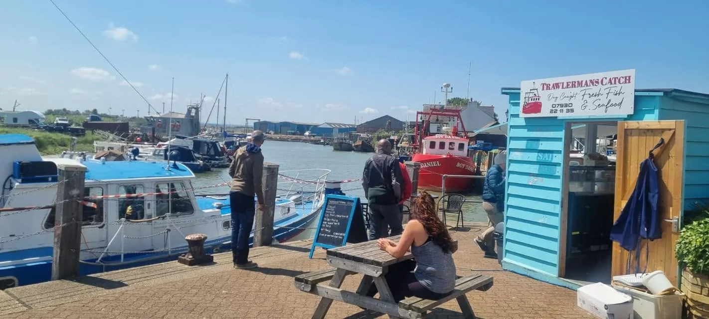 Boats beside The Little Blue Hut at Queenborough Harbour